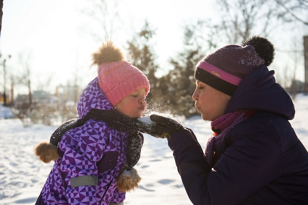 Mother and her little daughter enjoying beautiful winter day