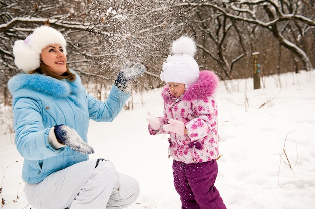 Mother and her little daughter enjoying beautiful winter day