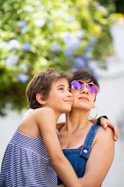 Mother and her little daughter traveling together in urban background