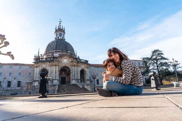 A mother and her son sitting in the Sanctuary of Loyola Baroque church of Azpeitia Gipuzkoa shrine