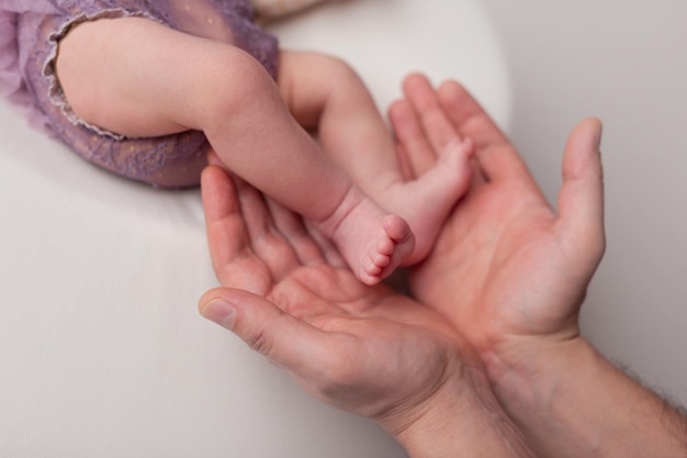 Mother hold feets of newborn baby