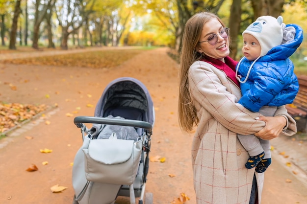 Mother holding baby in arms in park