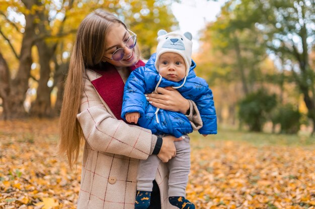 Mother holding baby in arms in park