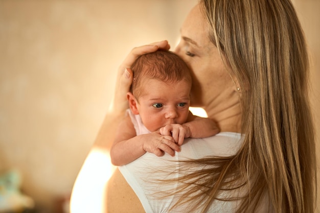 Mother holding her newborn baby in hands