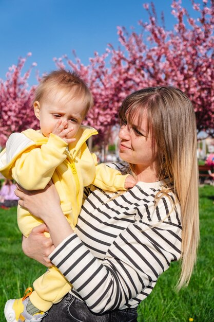 A mother holds her baby in her arms