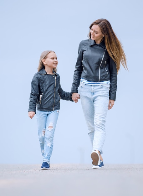 Mother holds her daughter's hand tightly