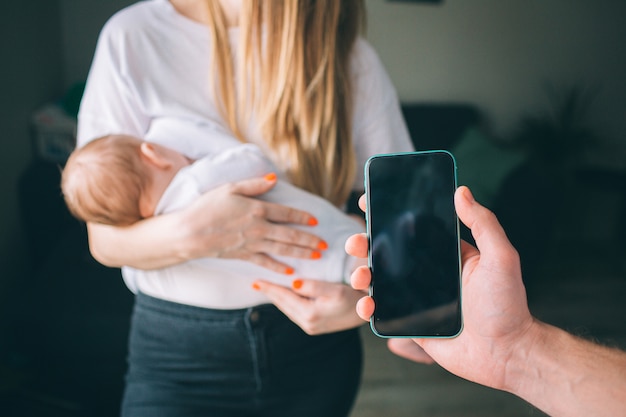 Mother holds a newborn baby in her arms