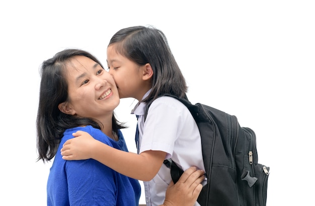 mother hug and kiss cute girl student 