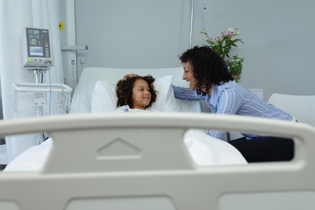 Photo mother interacting with her son in the ward at hospital