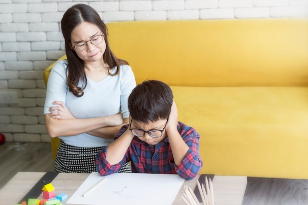 Mother is angry at her son doing homework