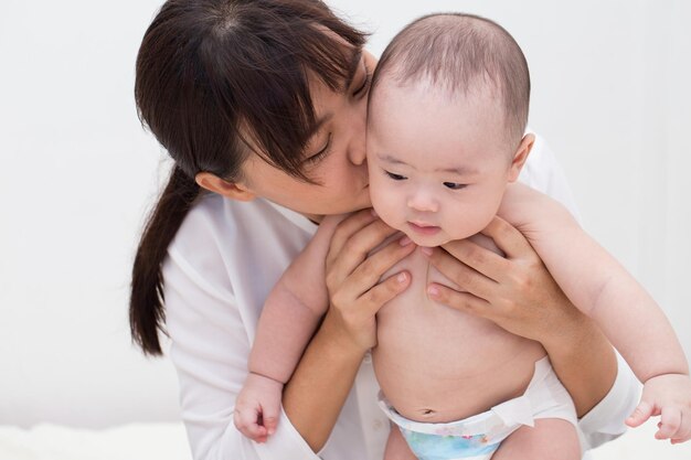 엄마가 집에서 귀여운 아들을 키스하고 있어