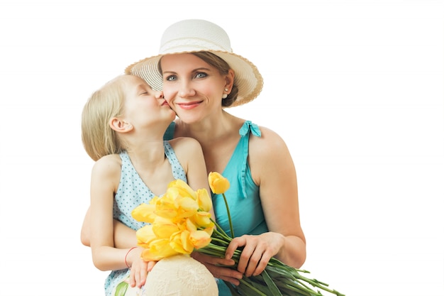 Mother kissing daughter isolated on white