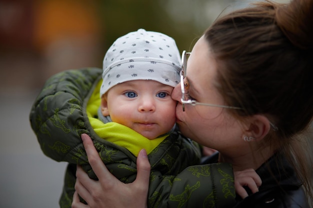 A mother kissing her baby boy