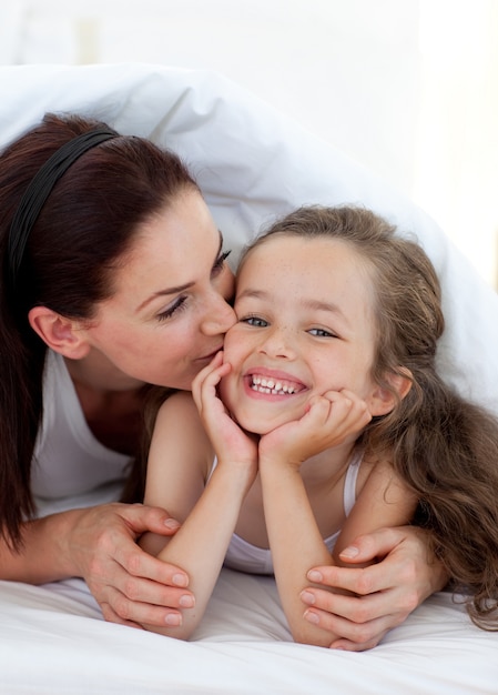 Mother kissing her daughter