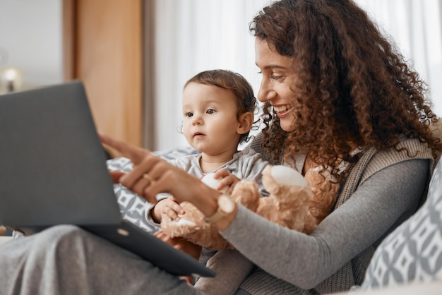 Photo mother laptop or child online for education skills development or knowledge on house sofa pointing talking or baby learning on social media or elearning course at home with mom or single parent