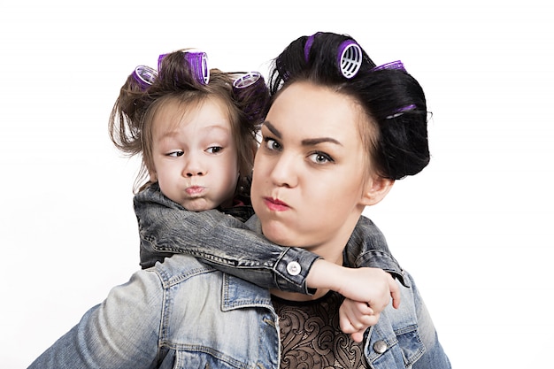 Mother and little daughter in hair curlers