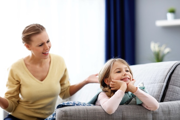 Mother and little daughter having argument at home