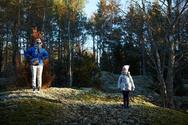 Mother and little daughter travel in mountains