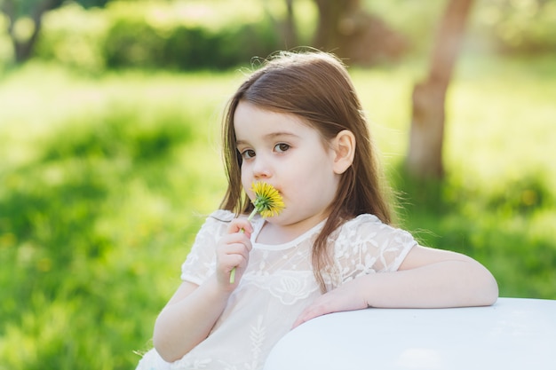 Mother and a little daughter walk in the spring blooming Apple