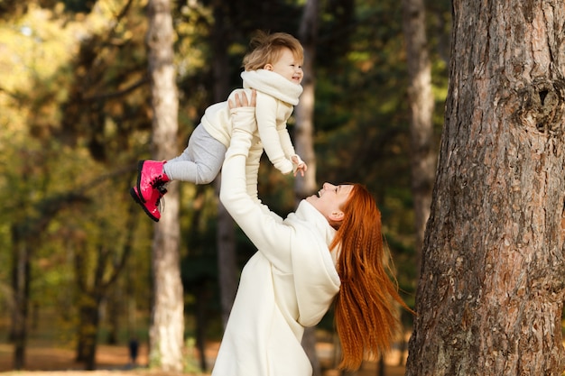 Mother and little daughter walking in the park