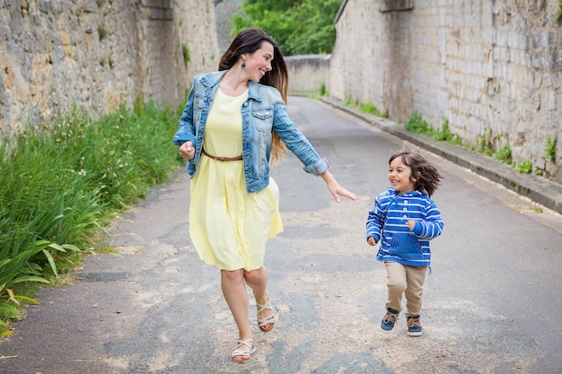 Mother and little eastern handsome baby boy playing outdoor in old town