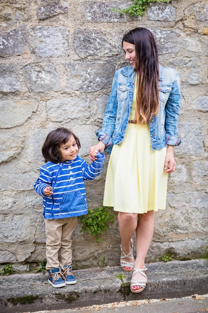 Mother and little eastern handsome baby boy playing outdoor in old town