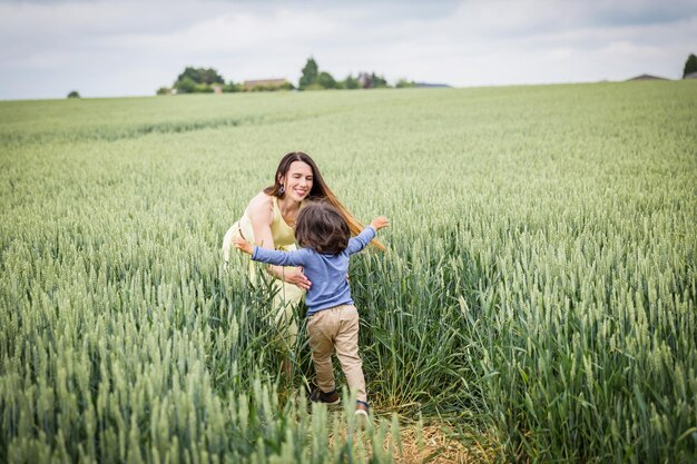 Mother and little eastern handsome baby boy walking in the field