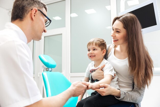 Mother and little son visiting dentist