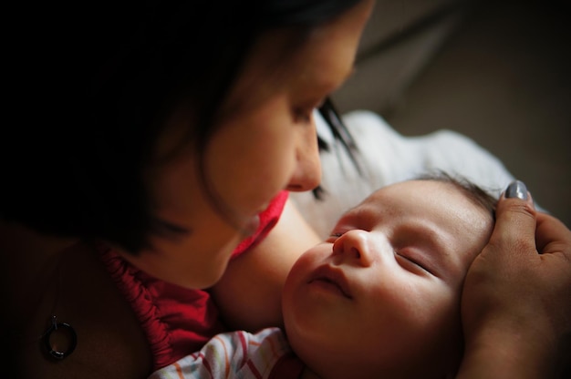 Mother looking at her sleeping baby