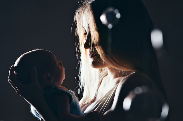 mother looks at the sleeping newborn