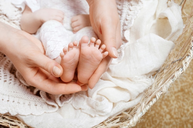 Mother making foot massage for her newborn baby