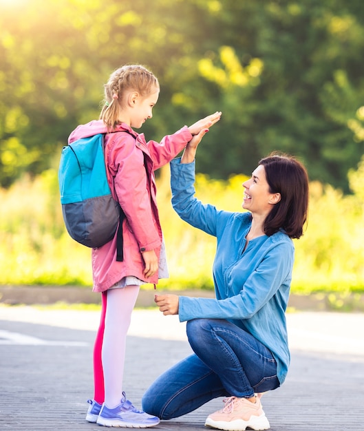 Mother meeting schoolgirl after lessons