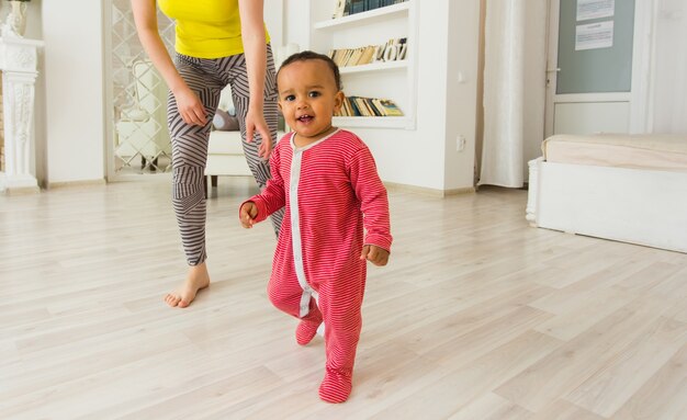 Mother And Mixed Race Baby Playing At Home.