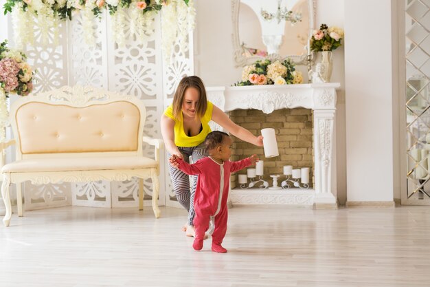 Mother And Mixed Race Baby Playing At Home.