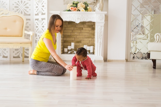 Mother And Mixed Race Baby Playing At Home.