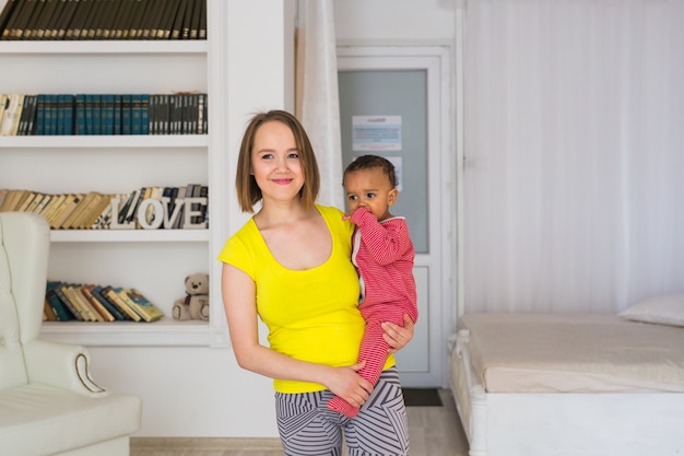 Mother And Mixed Race Baby Playing At Home.