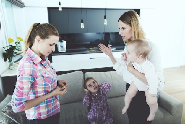 Photo mother and nanny have conflict in living room