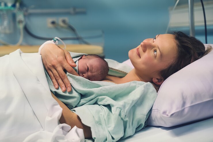 mother and newborn child birth in maternity hospital mom hugging her newborn baby after delivery