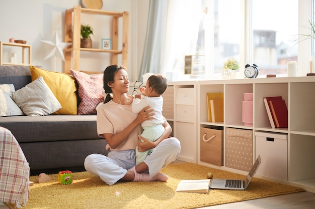 Mother playing with baby at home