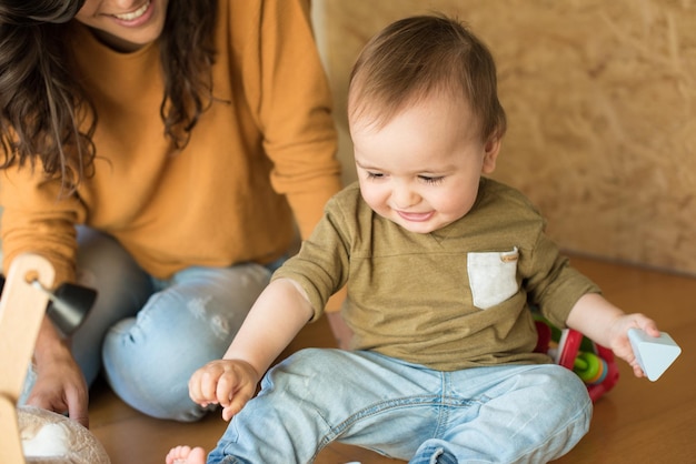 Mother playing with her baby - education methods concept