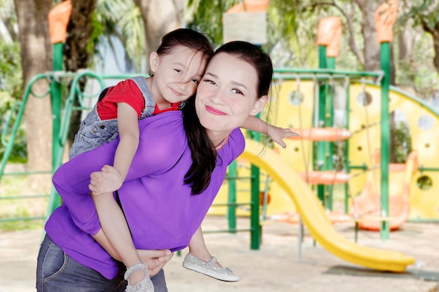 Mother playing with her daughter in the playground