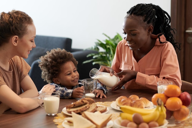 Mother Pouring Milk For Son