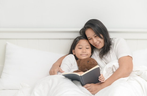 Mother read book with daughter 