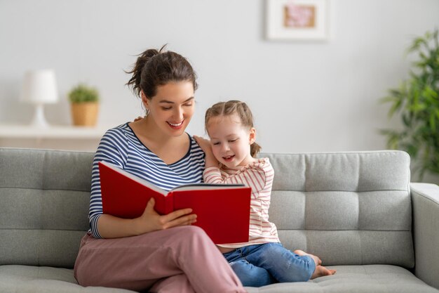 Mother reading a book to daughter