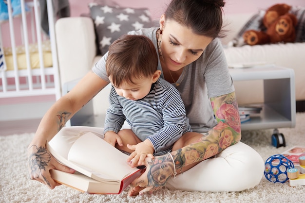 Mother reading book to her son