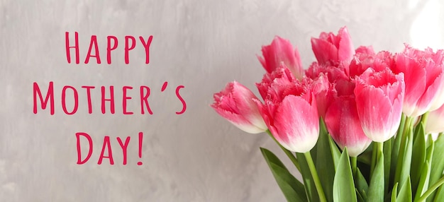 Mother's Day banner Beautiful pink tulips and text Happy Mother's Day Greeting card for a holiday