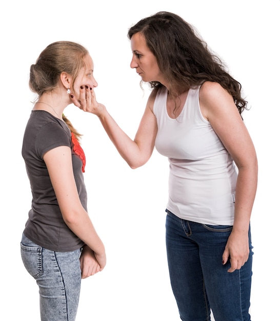 Mother shouting at her teenage daughter on a white wall