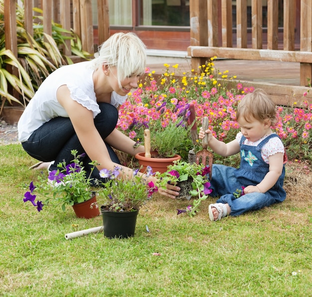 Mother showing her daughter a flower 