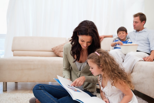 Mother showing photo album to daughter