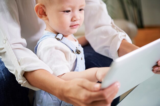 Mother showing tablet to baby